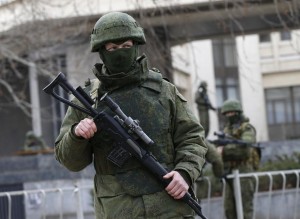 Armed men patrol around the regional parliament building in the Crimean city of Simferopol