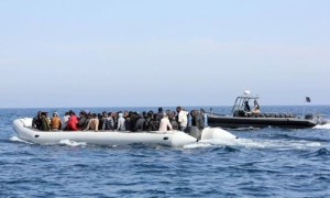 Libyan coast guards escort a boat carrying illegal migrants, who had hoped to set off to Europe with the help of people smugglers from the coastal town of Garabulli, towards the Libyan navy to the capital, Tripoli, prior to their arrest on June 6, 2015. Libya has a coastline of 1,770 kilometres (more than 1,000 miles). It is just 300 kilometres from the Italian island of Lampedusa, which many migrants fleeing poverty and conflict aim for as their gateway to Europe. AFP PHOTO / MAHMUD TURKIA