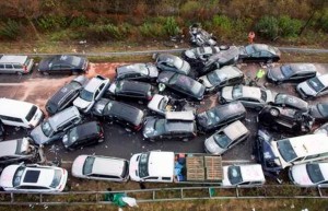epa03008583 A general view of the aftermath of a car pile up that took place overnight on the A31 motorway between Heek and Gronau-Ochtrup in Germany, 19 November 2011. One woman and two men died in a 52-car pileup in foggy conditions late on 18 November on an expressway in northern Germany, authorities said. The accident left 35 people injured, including 14 in serious condition, a police spokeswoman in North Rhine-Westphalia state said. She described the wreckage-strewn roadway was a 'debris field.' Many of the injured were trapped in their cars and had to be freed by emergency workers, who rushed to the scene from a wide area. It was not immediately clear if the reduced visibility from fog was the cause of the accident, the spokeswoman said.  EPA/WILFRIED GERHARZ  EPA/ROLF VENNENBERND