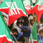 Militants hold Forza Italia's flag befor