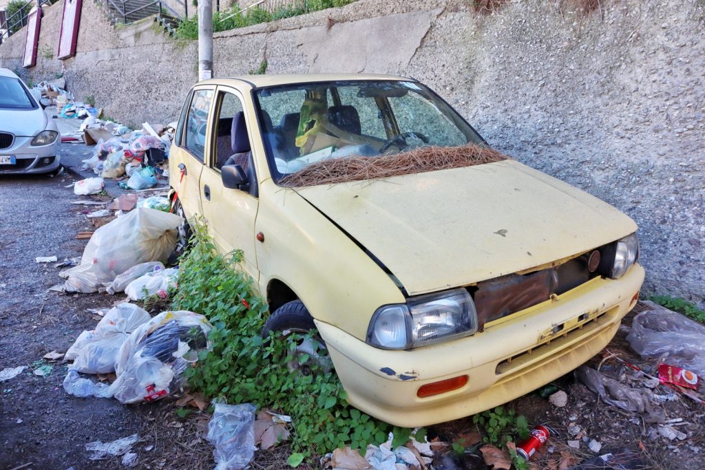 Macchina abbandonata e spazzatura in via Trieste
