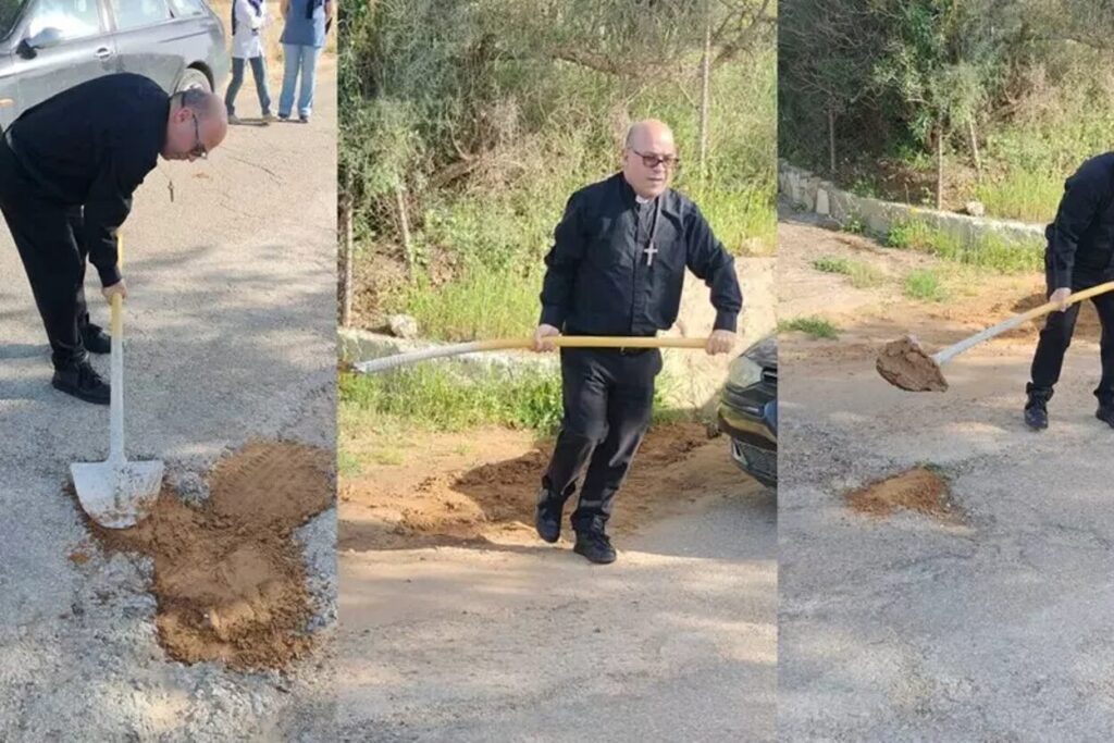 parroco ripara buche in strada